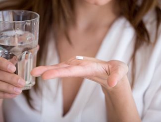 Lady is about to take pill