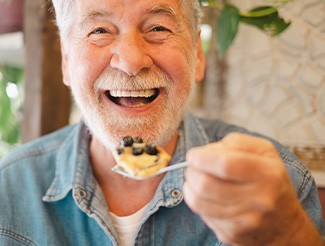 Senior man about to eat some cake