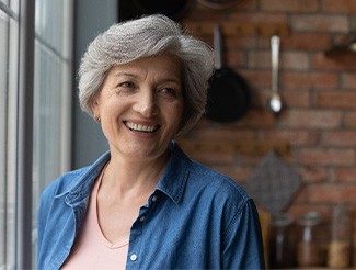 Woman smiling by a window