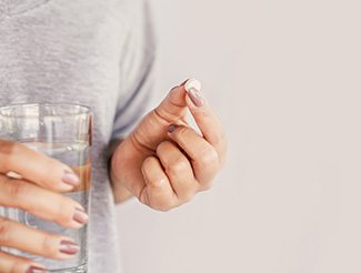 Woman taking a pill