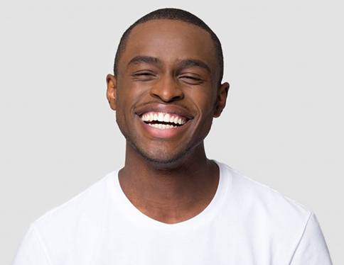 Man smiling wide with whitened teeth